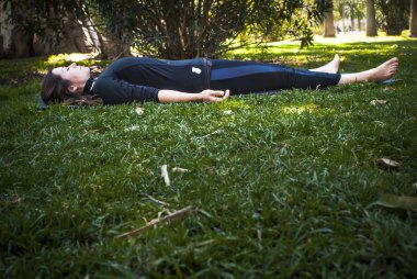 Güneşli bir günde pratik Yoga parkta güzel kadın