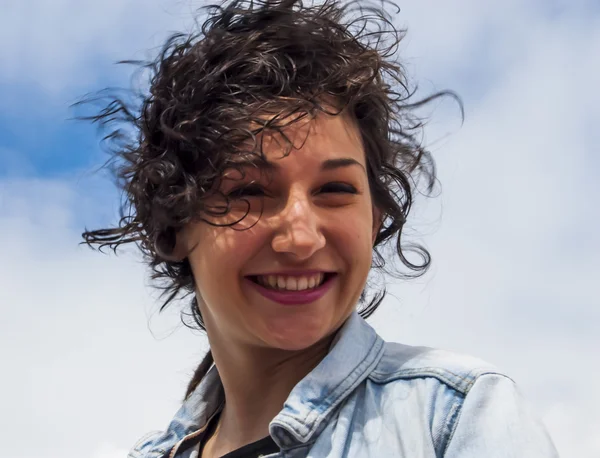 Mulher bonita com um céu com nuvens de fundo — Fotografia de Stock