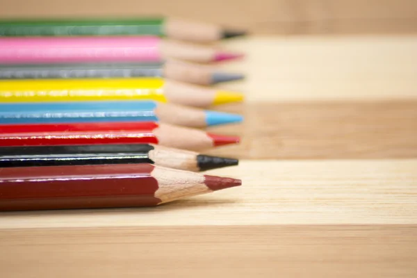 Colored pencils isolated on wooden background — Stock Photo, Image