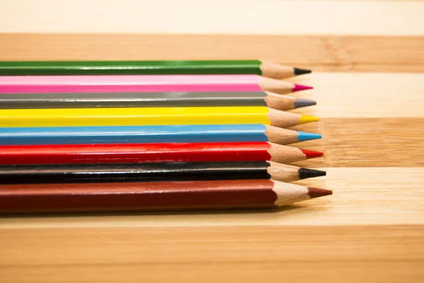 Colored pencils isolated on wooden background — Stock Photo, Image