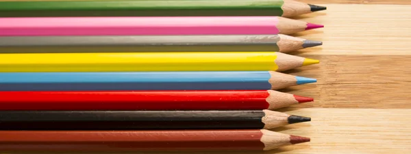 Colored pencils isolated on wooden background — Stock Photo, Image