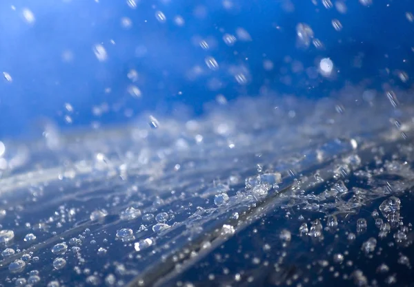 Raindrops falling on an umbrella — Stock Photo, Image