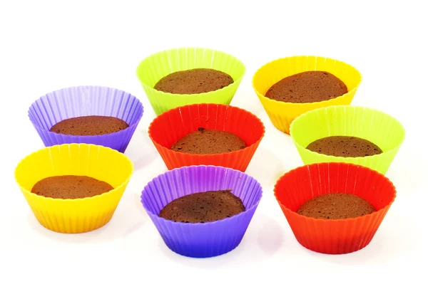 Chocolate muffins in silicone holders of many colors — Stock Photo, Image