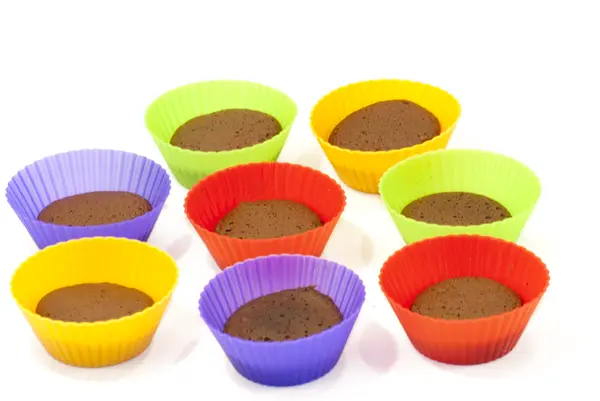 Chocolate muffins in silicone holders of many colors — Stock Photo, Image