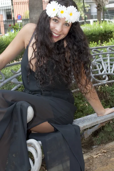 Mulher bonita com uma coroa de flores brancas na cabeça em um — Fotografia de Stock