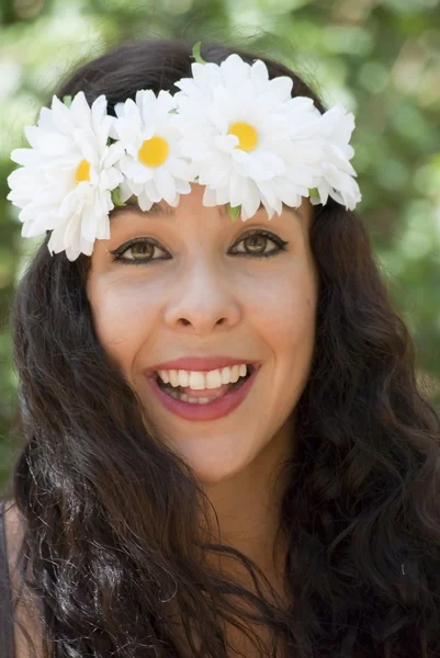 Mooie vrouw met een krans van witte bloemen op haar hoofd in een — Stockfoto