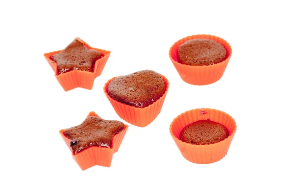 Chocolate muffins in silicone holders with form of heart and sta — Stock Photo, Image