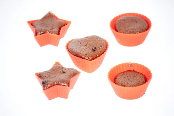 Chocolate muffins in silicone holders with form of heart and sta — Stock Photo, Image