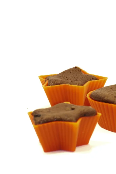 Chocolate muffins in silicone holders with form of heart and sta — Stock Photo, Image