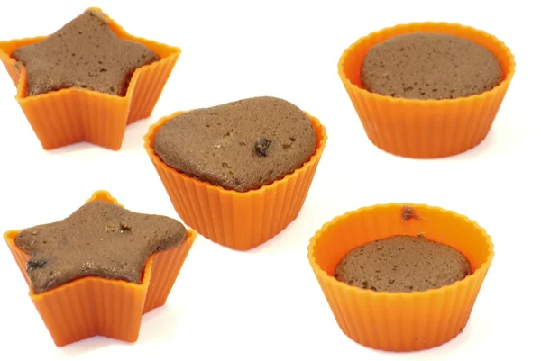 Chocolate muffins in silicone holders with form of heart and sta — Stock Photo, Image