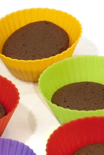 Chocolate muffins in silicone holders of many colors — Stock Photo, Image