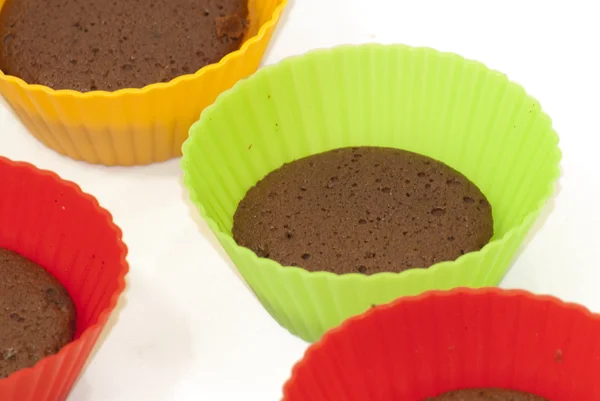 Chocolate muffins in silicone holders of many colors — Stock Photo, Image