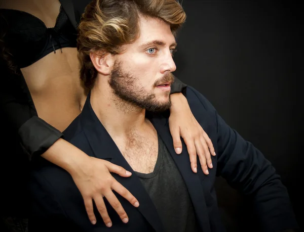 Handsome guy with a girl hands resting on his shoulder — Stock Photo, Image