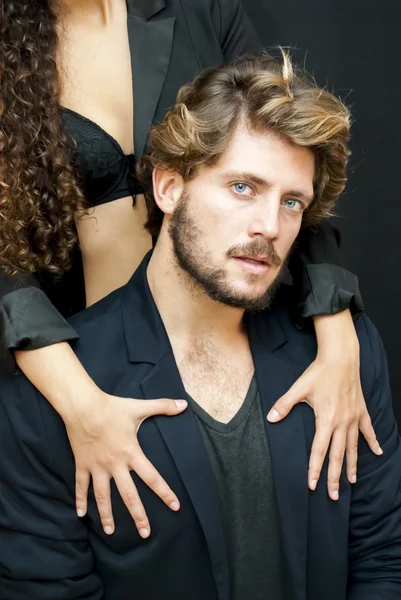 Handsome guy with a girl hands resting on his shoulder — Stock Photo, Image