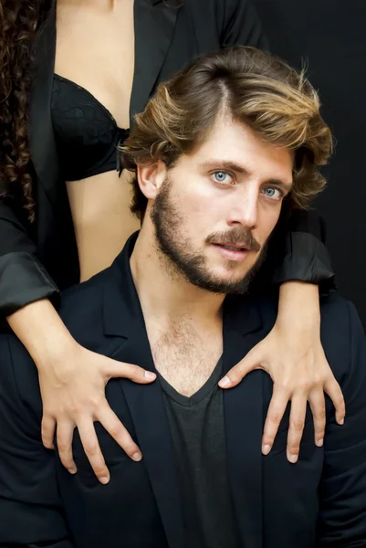 Handsome guy with a girl hands resting on his shoulder — Stock Photo, Image