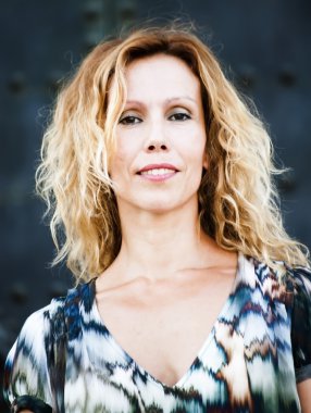 Eski bir kapı önünde güzel orta yaşlı kadın