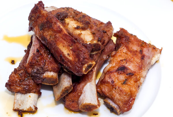 Roasted pork ribs on a white plate