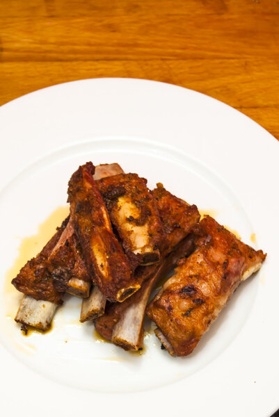 Roasted pork ribs on a white plate