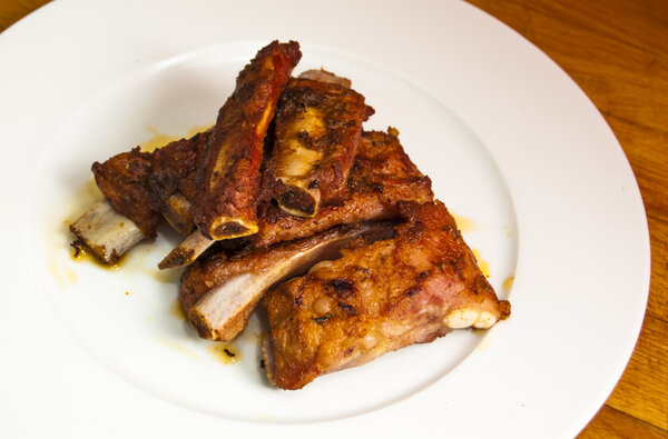 Roasted pork ribs on a white plate