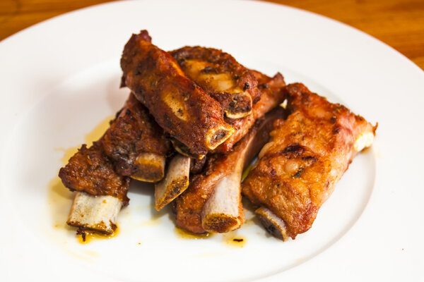Roasted pork ribs on a white plate