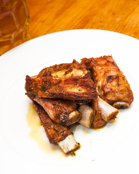 Roasted pork ribs on a white plate