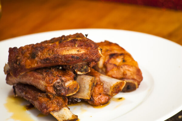 Roasted pork ribs on a white plate