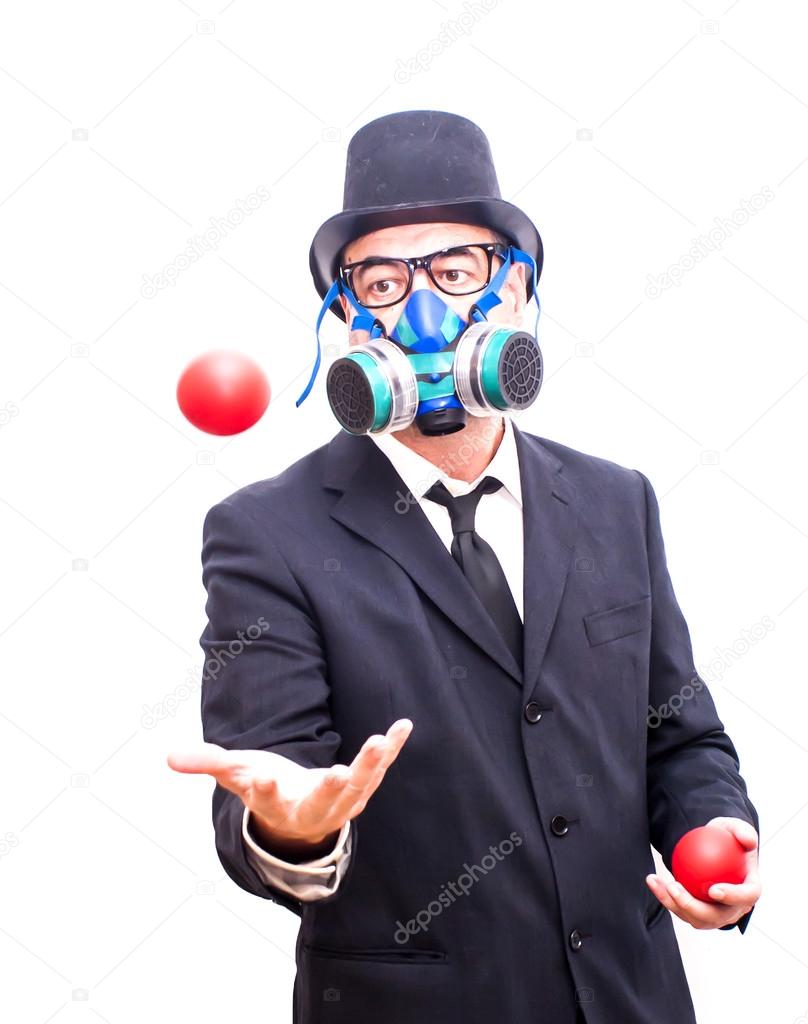 Businessman with gas mask  that is juggling with a red balls