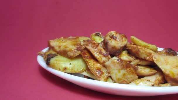 Plate of octopus with paprika on red background — Stock Video