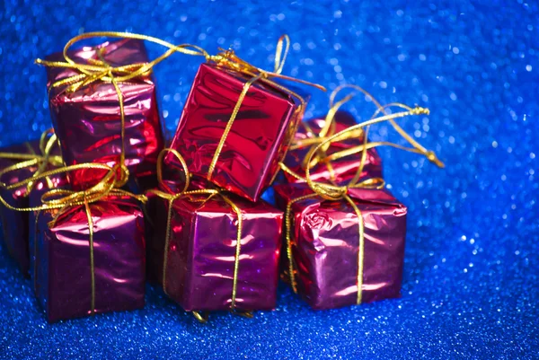 Gift packages on bright blue background — Stock Photo, Image