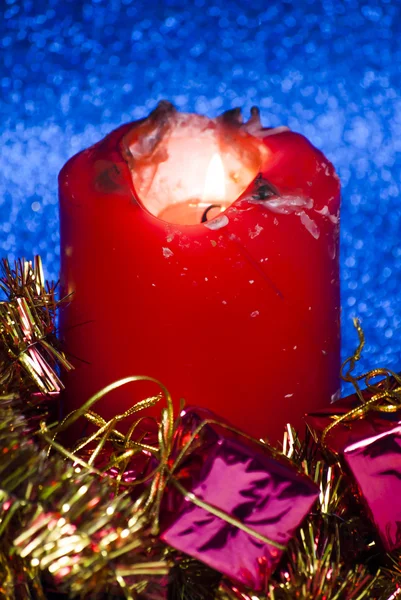 Christmas gifts with a lighted candle — Stock Photo, Image