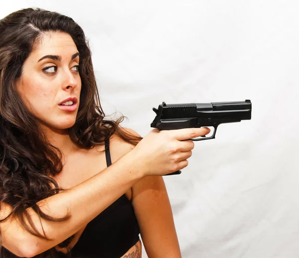 Portrait de belle jeune femme brandissant une arme — Photo