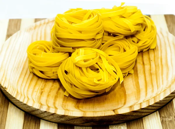 Italian noodle nest on wooden — Stock Photo, Image