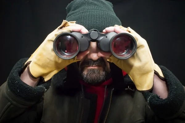 Explorer looking horizon with binoculars on black background — Stock Photo, Image