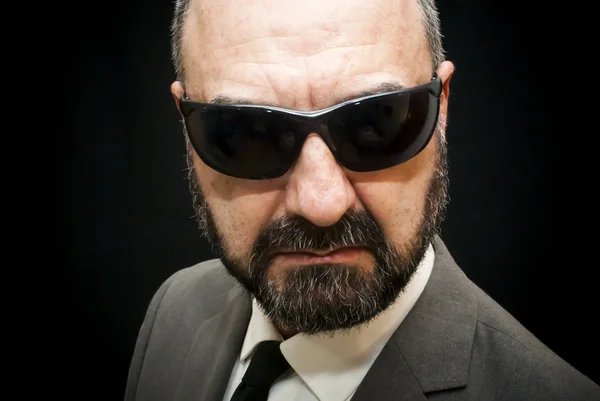 Handsome business man, bald and beard, over black — Stock Photo, Image