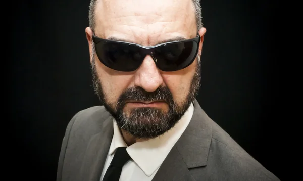 Handsome business man, bald and beard, over black — Stock Photo, Image