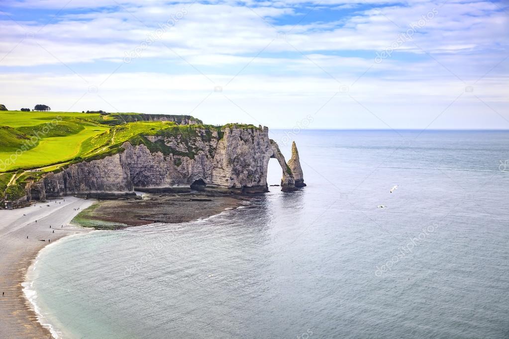 Etretat Aval cliff and rocks landmark and blue ocean . Normandy,