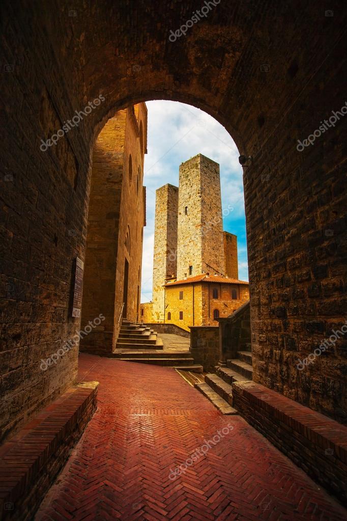 San Gimignano sunset from a tunnel, towers in central Erbe squar ...