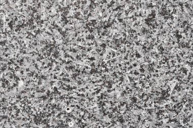 Yüksek çözünürlüklü, pürüzsüz arka plan yapısı kaba granit doğal bir taşın. Yüzeyde siyah, gri ve beyaz mineral kristallerinin benekli bir deseni var..