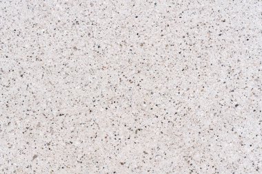 Beyaz terrazzo ya da kuvars yüzeyinin yüksek çözünürlüklü üst görüntüsü. Küçük gri ve kahverengi taşlı pürüzsüz desen, iç tasarım ve mimari arka plan için ideal