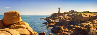 Ploumanach lighthouse in pink granite coast, Brittany, France. clipart