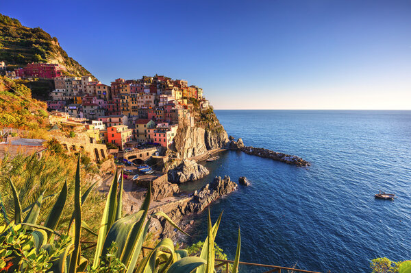 Manarola village, rocks and sea at sunset. Cinque Terre, Italy