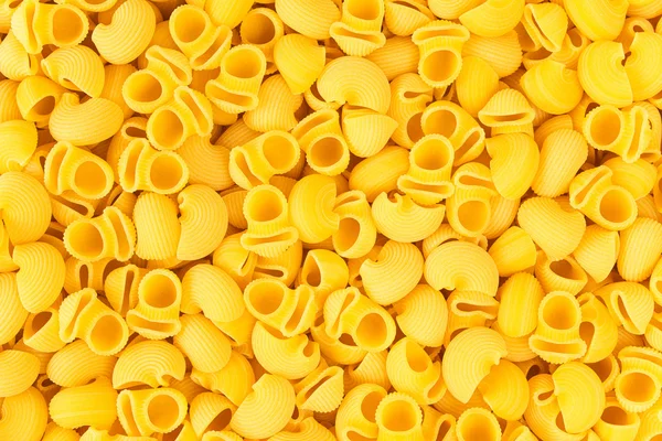 Italien Pipe Rigate Macaroni Pâtes alimentaires crues fond ou textur — Photo