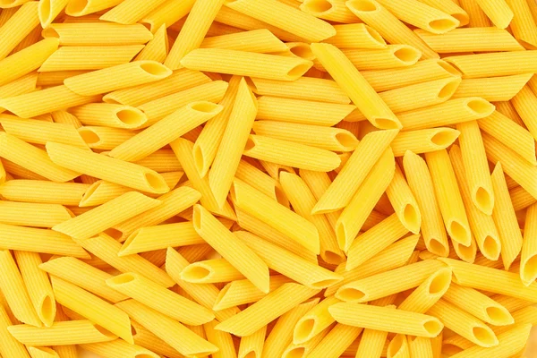 Italiano Penne Rigate Macarrones Pasta fondo de alimentos crudos o textu —  Fotos de Stock