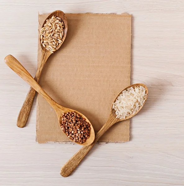 木制的勺子和荞麦、 水稻、 燕麦，纸张菜单. — 图库照片