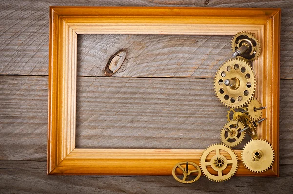 Wooden frame and mechanical clock gears — Stock Photo, Image