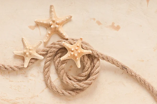 Hvězdice a lano na staré papírové pozadí — Stock fotografie