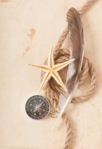 Compass, rope and starfish on the old paper background — Stock Photo, Image