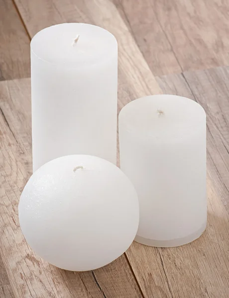 Decorative candle on old wooden background — Stock Photo, Image