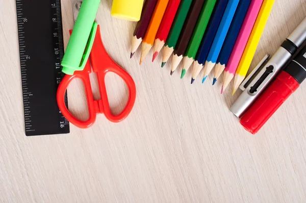 Colored pencils on a wooden background — Stock Photo, Image