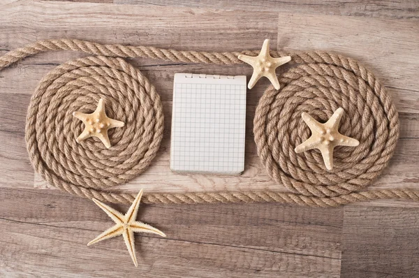 Paper, rope, starfish on the old wooden background — Stock Photo, Image